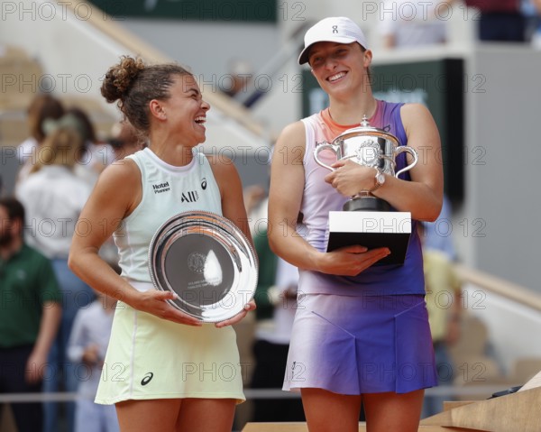 French Open 2024 Champion Iga Swiatek of Poland and runner up Jasmine Paolini during the trophy presentation at Roland Garros, Paris, France.