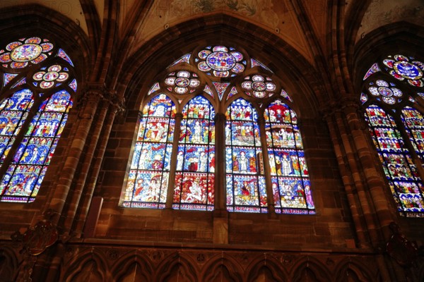 Strasbourg Cathedral, Cathedral of Our Lady, Cathédrale Notre-Dame, Cathedral, Strasbourg, Strasbourg, Bas-Rhin, Alsace, Alsace, France, Several stained glass windows with vivid religious scenes, framed in Gothic arches, Strasbourg, Strasbourg, Bas-Rhin, Alsace, Alsace, France, Europe