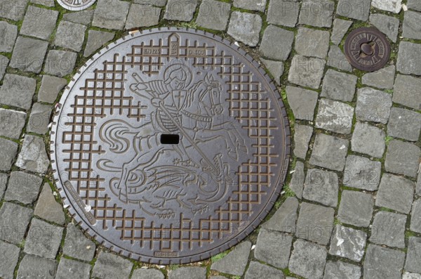 Manhole cover with coat of arms of the municipality of Stein am Rhein, dragon slayer, Canton Schaffhausen, Lake Constance, Untersee, Switzerland, Europe