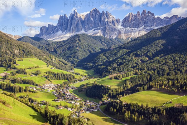 Fabulously beautiful valley in South Tyrol. Charming old little church in the Val de Funes. Dolomites on a sunny autumn day. The beautiful village in the Dolomites Santa Maddalena
