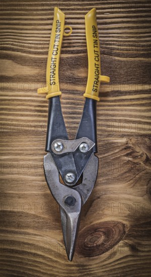 Sharp metal steel cutter on vintage wooden board construction concept