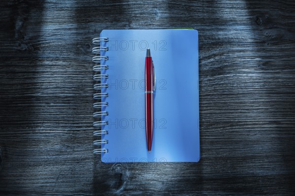 Set of notebooks pen on vintage wooden board