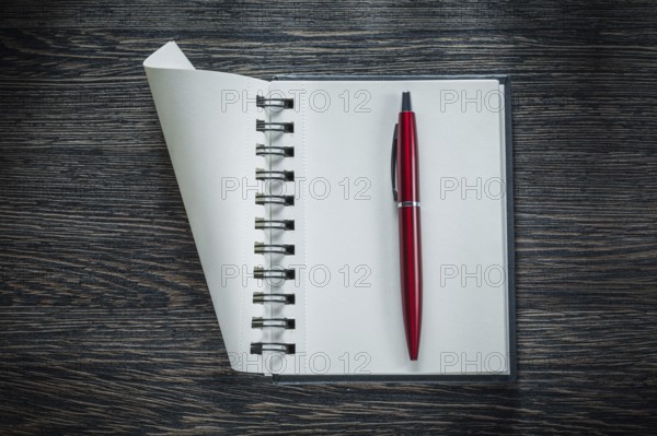 Spiral blank notebook ballpoint pen on vintage wooden board