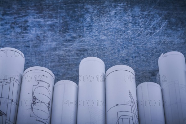 Scratched shiny metallic background with composition of blueprints construction concept