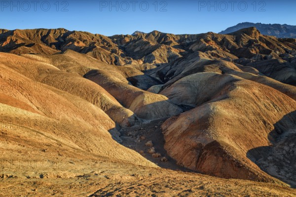 Zabriskie Point, sunrise, sun, golden path raod composed of sediments from Furnace Creek Lake, named after Christian Brevoort Zabriskie, Pacific Coast Borax Company, movie by Michelangelo Antonioni