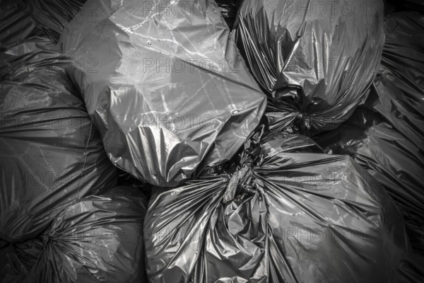 Background garbage bag, black waste, Garbage dump, Garbage, Rubbish, Plastic Bags, stack of junk. Ideal for concepts or texture