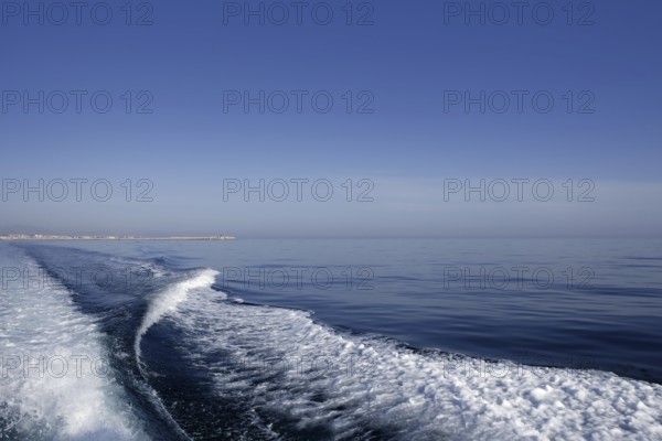 Blue sea ocean with boat wake, prop wash foam