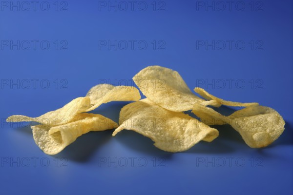 Potato fried chips still over blue background