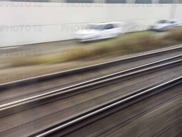 Tracks and rails in motion from a moving train. Symbolic photo for train journey, speed and dynamics. Austria