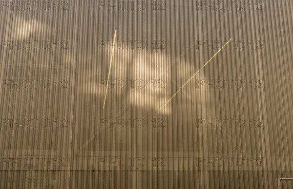 Seoul, South Korea, March 8, 2019: Low angle view of exterior wall made of corrugated see-through metal, Interior lights visible through wall, Asia