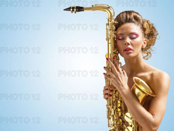 Retro photo of a sleepy naked pin up woman with closed vintage winged eyes embracing a saxophone like a tender lover on a blue background