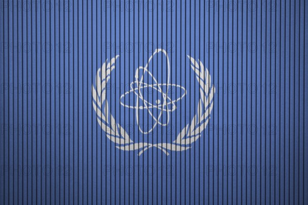 IAEA Flag painted on the cracked grunge concrete wall, International Atomic Energy Agency