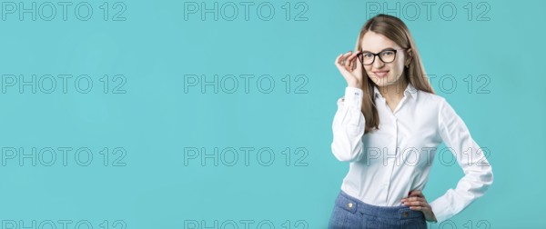 Blank for advertising. portrait young caucasian woman worker teacher coach mentor in white shirt office style business lady leader advertising glasses eyesight blue isolated colour background