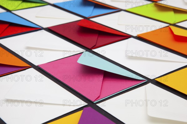 Composition with white and colored envelopes on the table. The photo suitable for various holidays and anniversaries