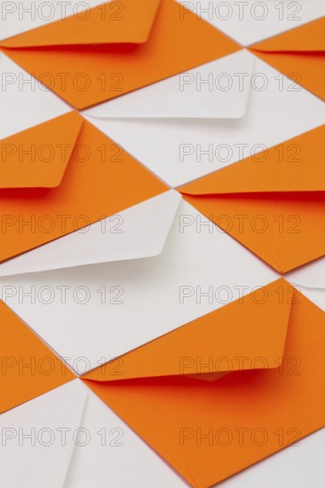 Composition with white and orange envelopes on the table