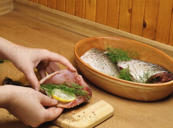 Fish carcass with spices on wooden hardboard, prepared for cooking