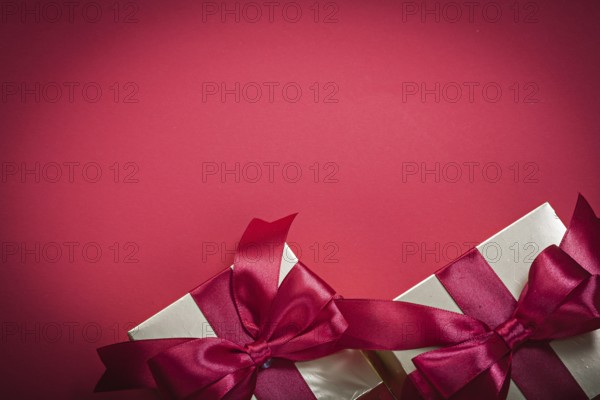 Wrapped present boxes on red background top view holidays concept