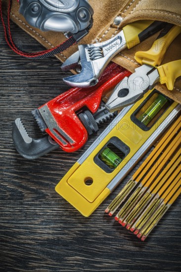 Building belt with construction tooling on wooden board