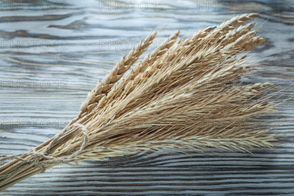 Bunch of wheat ears on vintage wooden board