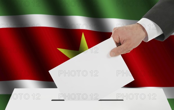 The Surinam flag and the hand with the bulletin about the ballot box