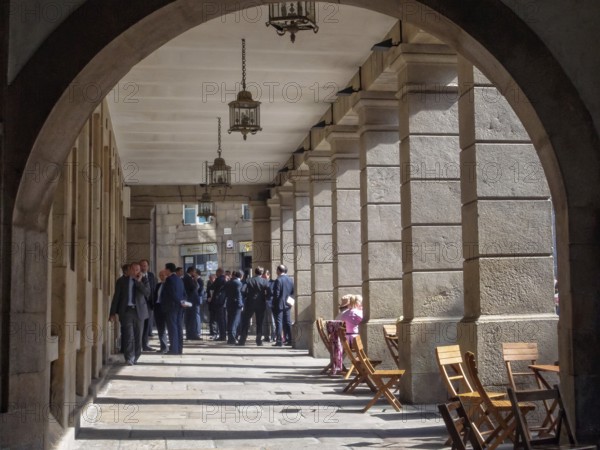 Group of businessmen under the colonnade of Cervantes Square, Santiago de Compostela, Galicia, Spain, Europe