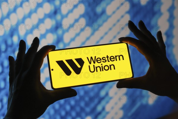 In this photo illustration, the Western Union logo is displayed on a smartphone screen