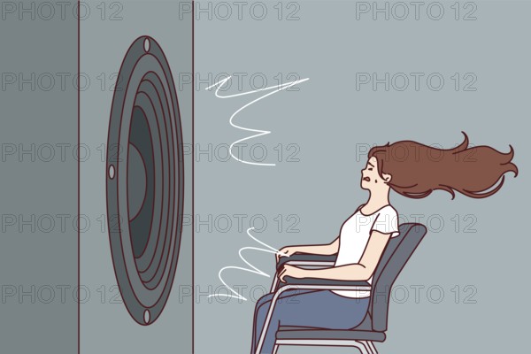 Deafened woman near giant subwoofer from music center listening to loud rhythmic track with bass sitting in chair. Subwoofer with round speaker produces loud sound waves for girl who loves rock songs