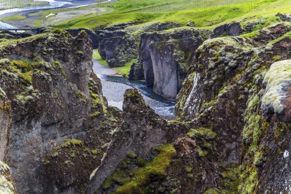 Iceland. The beautiful and mysterious canyon Fyadrarglyufur. Cloudy summer day. River with glacial water flows between bizarre cliffs. The concept of eco, active and photo tourism