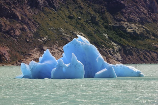 Unique lake Viedma in arid Patagonia. Huge white and blue icebergs floating in the icy water of emerald lake in Argentina