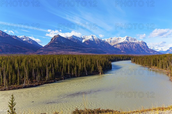 Rocky Mountains of Canada. Mountain peaks covered with snow and glaciers. This artificial Abraham lake. Picturesque multicolor autumn landscape