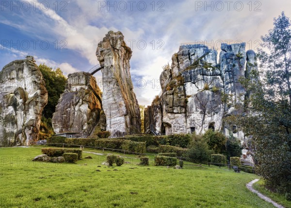 The 40 metre high Externsteine form a striking natural monument in a tranquil nature reserve in Germany. Surrounded by autumnal colours, the reflections of the rocks and foliage create a picturesque scene on the lake