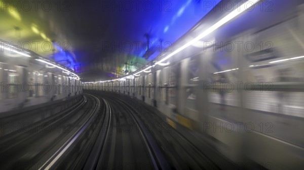 First person window perspective view of underground Paris subway tunnel with station and moving light
