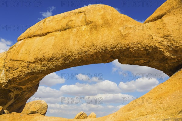 Natural group of smooth bald granites among the Namib Desert. Stone arch of Spitzkoppe, Namibia. Concept of extreme and ecological tourism