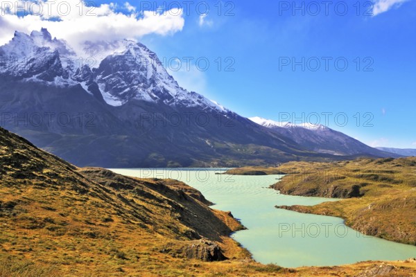Asure Lake Pehoe water at the foot of the magnificent snow-covered cliffs of Los Kuernos. National Park Torres del Paine, Chile, South America
