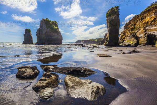 Exotic journey to the end of the world. North Island, New Zealand. Famous rocks Three Sisters on the Pacific coast. The concept of ecological and phototourism