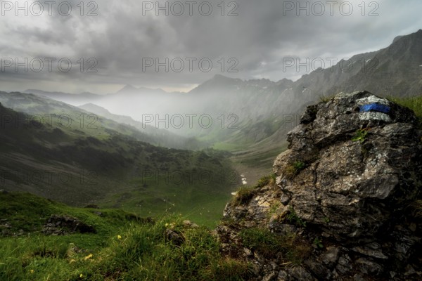 View from Mountain Entschenkopf near Oberstdorf in dynamic weather with rain