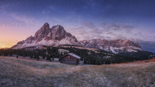 Passo Erbe under the mountain Peitlerkofel, or Sass de Putia before sunrise with wood hut