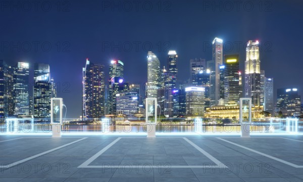 Empty parking lot with ev chargers glowing against the backdrop of singapore's illuminated skyline at night. 3D rendering
