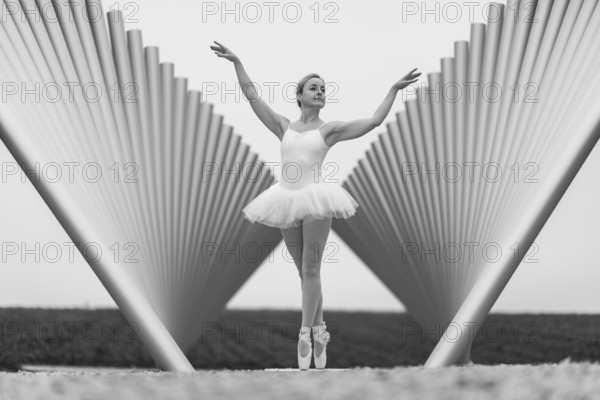 Black and white photograph of a ballerina in front of a modern sculpture, Emmendingen, Baden-Württemberg, Germany, Europe