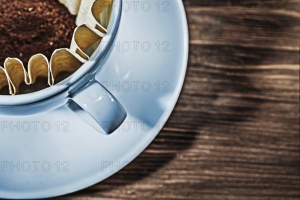 Very close up view cup with filter and grinded coffee