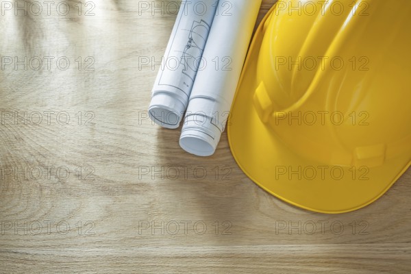 Building helmet blueprints on wooden board