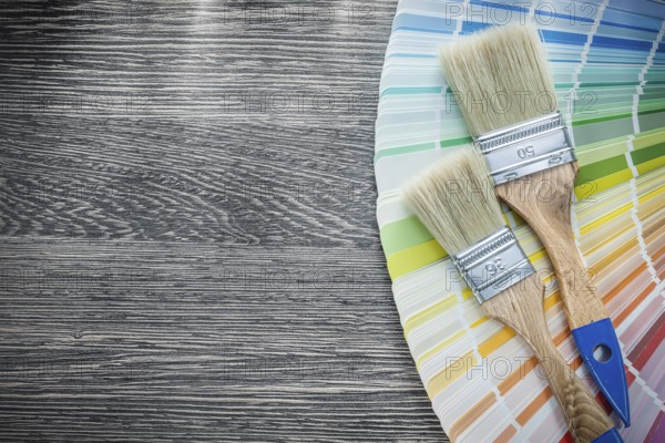 Paint brushes color palette on wood board