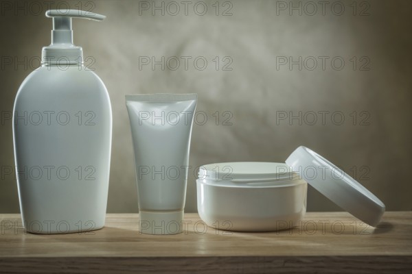 Body hygiene products two pump dispensers mockup blank white plastic bottles and facial cream in opened jar on wooden table