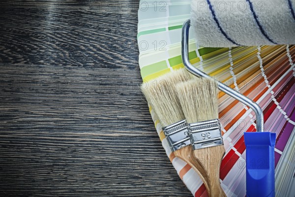 Paint brushes roller color pantone fan on wooden board