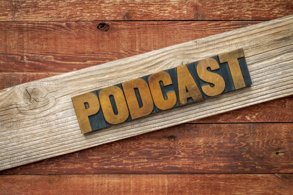 Podcast rustic sign - letterpress wood type over grained cedar plank against red barn wood