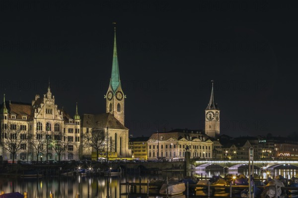 View of Limmat river with Fraumunster and st. Peter church in evening, Zurich