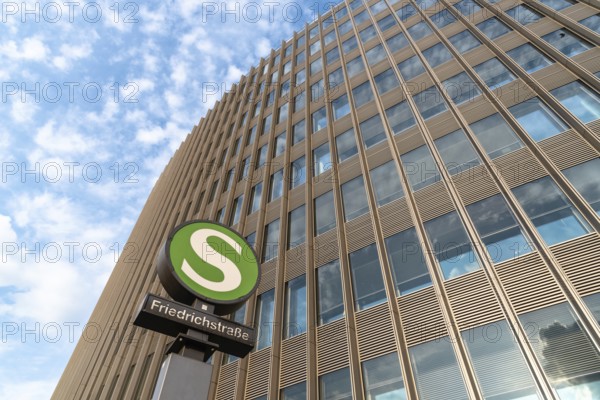 Berlin, Germany, July 28, 2019: Low angle view of Friedrichstrasse railway station sign against modern office building, Europe