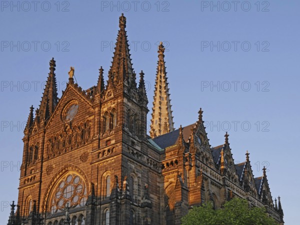 In the glowing evening light: the neo-Gothic St Peter's Church in Leipzig's southern suburbs. Saxony, Germany, Europe
