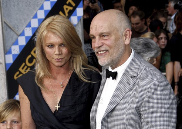 HOLLYWOOD, CA - SEPTEMBER 30, 2010: John Malkovich and Peta Wilson at the Los Angeles premiere of 'Secretariat' held at the El Capitan Theater in Hollywood, USA on September 30, 2010. Hollywood, California, USA, North America