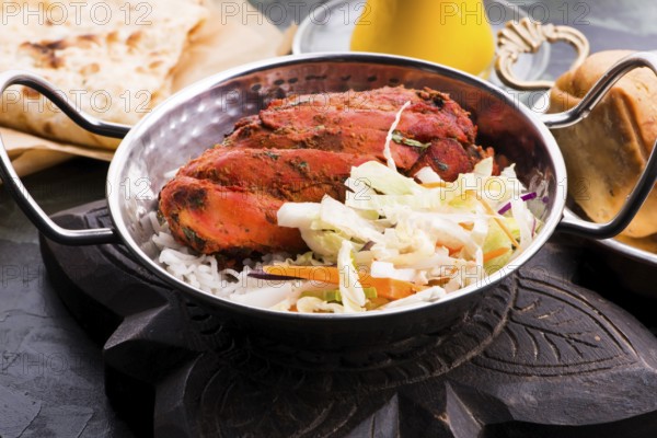 Close-up of a plate of chopped tandoori chicken